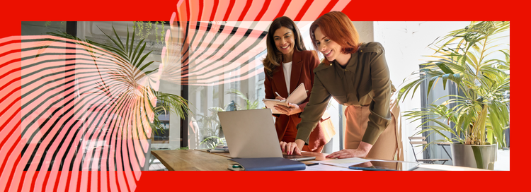 Two women looking at a laptop.