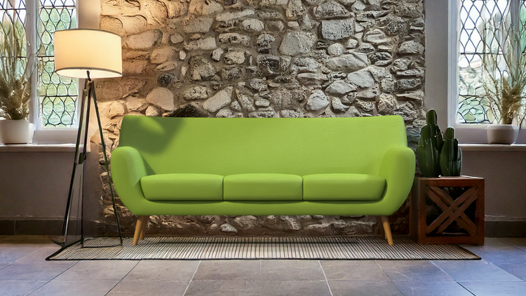 Image of a green couch with a lamp next to it.