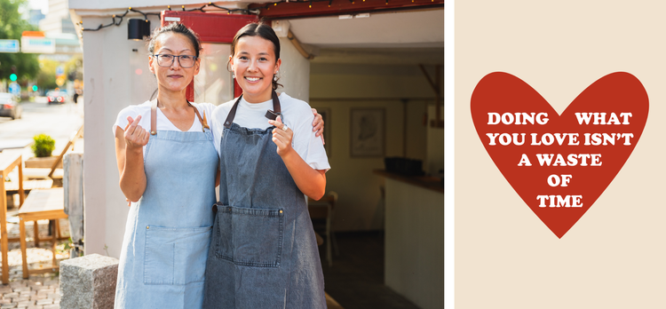 Two women make hearts with their fingers. Doing what you love isn't a waste of time.