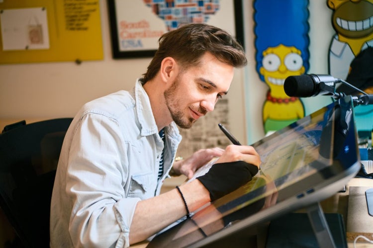 Tyler Pate in his workspace, designing the 2025 Adobe MAX customer anniversary pins.