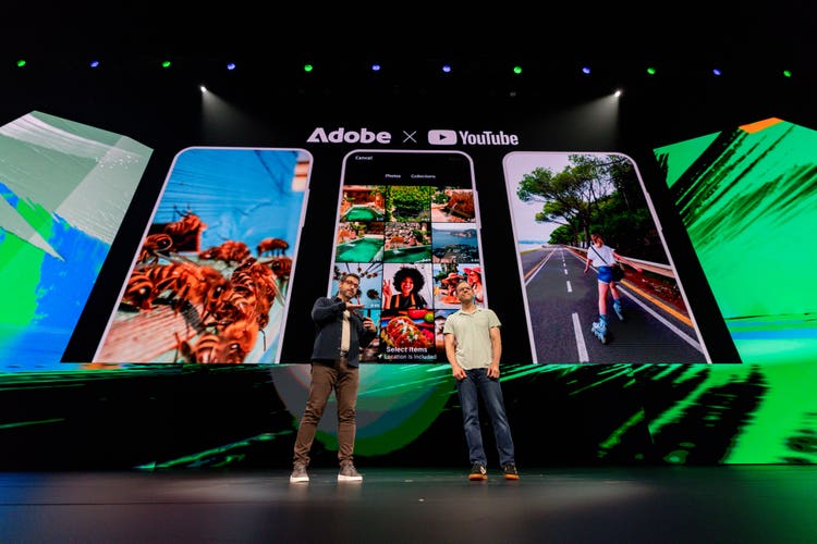 Two people on stage at Adobe MAX
