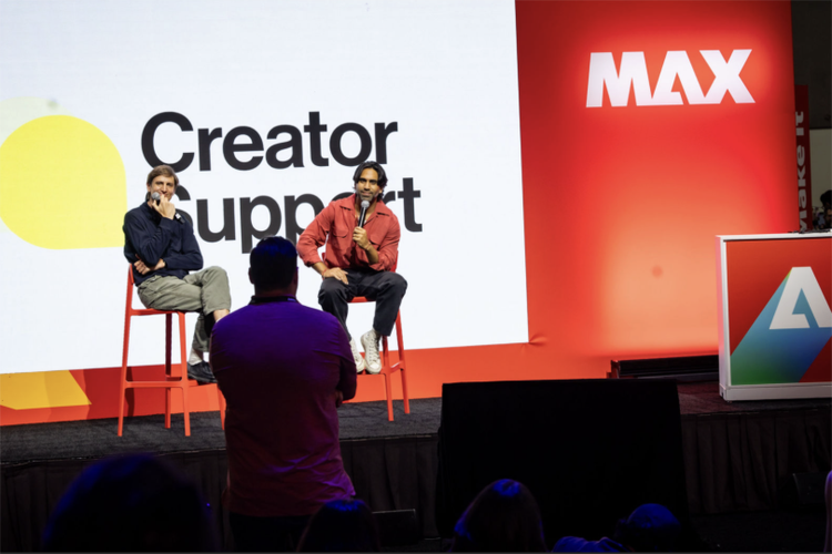 Two people on stage at Adobe MAX
