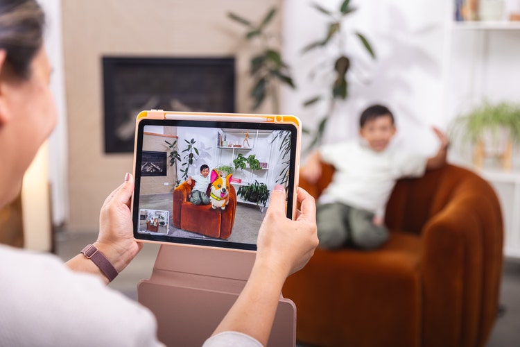 Tablet being used to take a picture of a child.