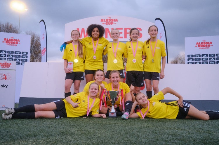 A group of girls in uniform posing for a photo AI-generated content may be incorrect.