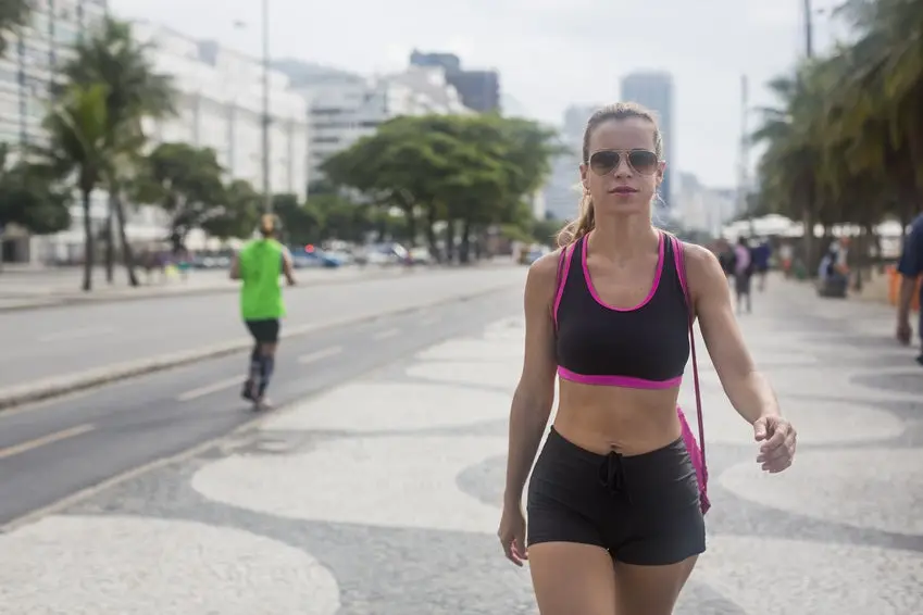 Brazil, Rio de Janeiro, sportive woman walking on pavement
