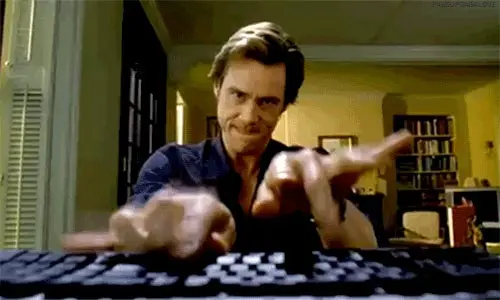 actor jim carrey escribiendo con ansiedad en su computador 