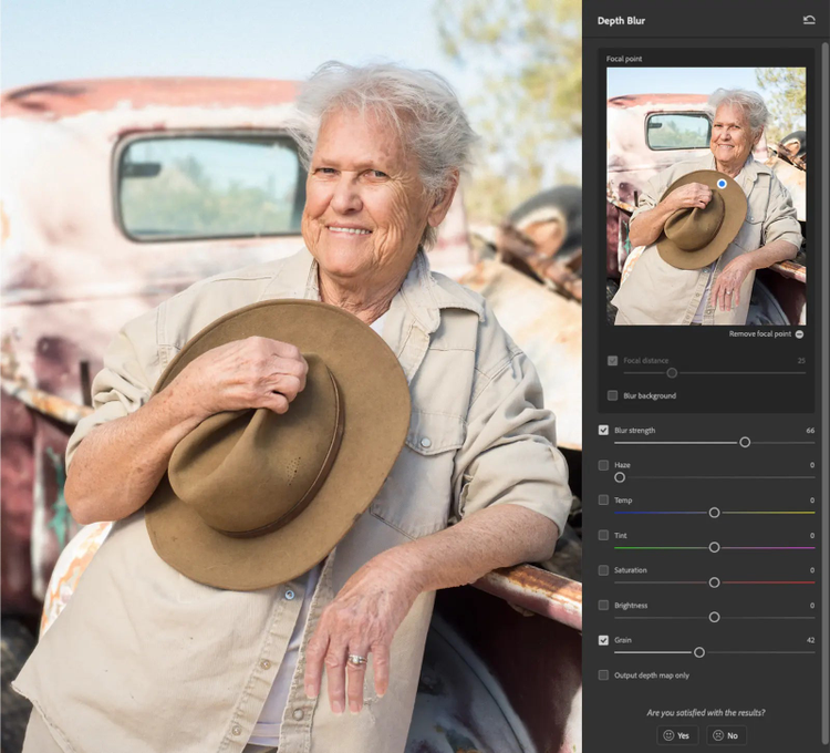 Funciones de edición de Photoshop: filtro de desenfoque de fondo con la muestra de un retrato de una señora que tiene un sombrero y está recostada sobre un carro