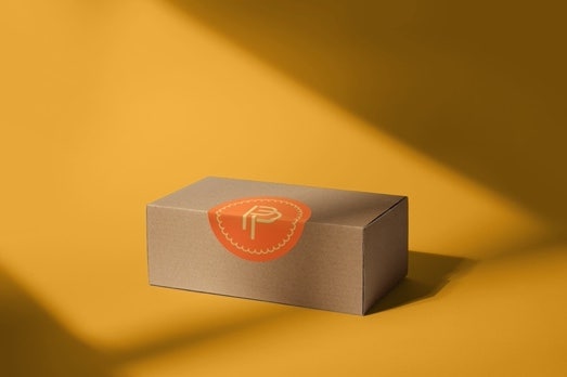 Image of a brown box with an orange label created using generative AI in Adobe Illustrator.
