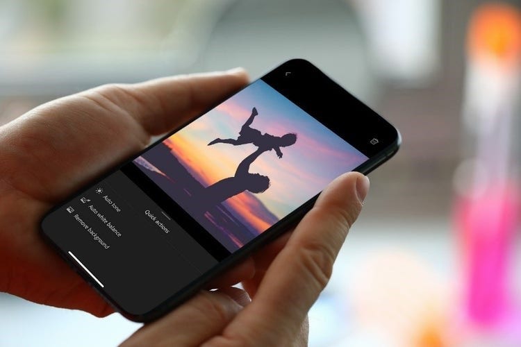 A person holding a cell phone Description automatically generated