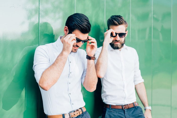 Two young modern businessman posing