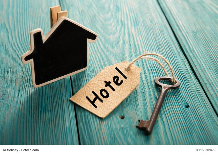 VIntage hotel key with tag on the wooden background