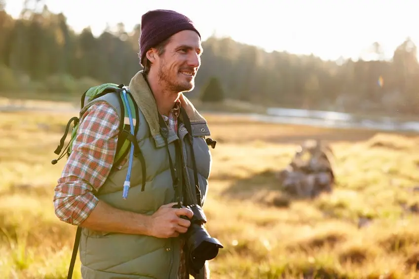 Man Hiking with camera in countryside