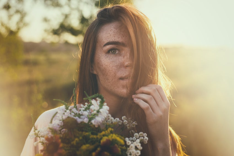 artistic portrait of freckled woman