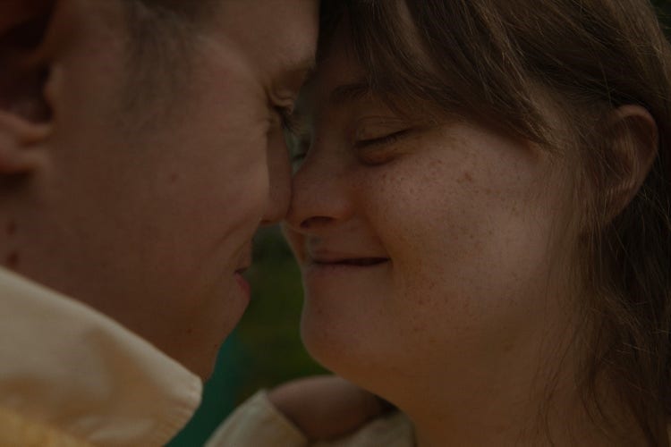 Two people touching noses affectionately.