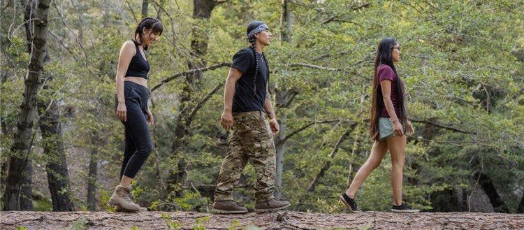 Indigenous friends hiking in nature.