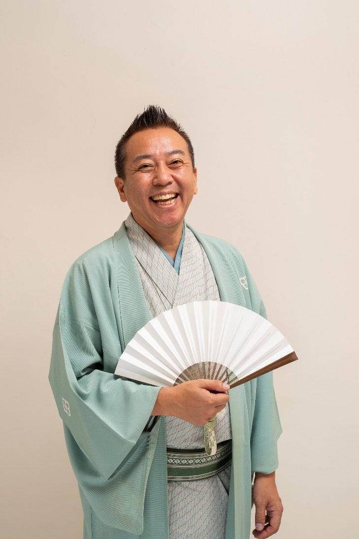 A person holding a fan Description automatically generated with low confidence
