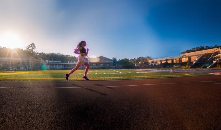 A person running on a track Description automatically generated