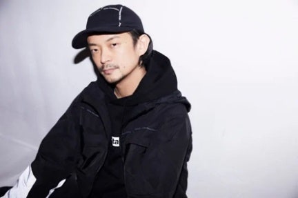A person in a black jacket and hat Description automatically generated