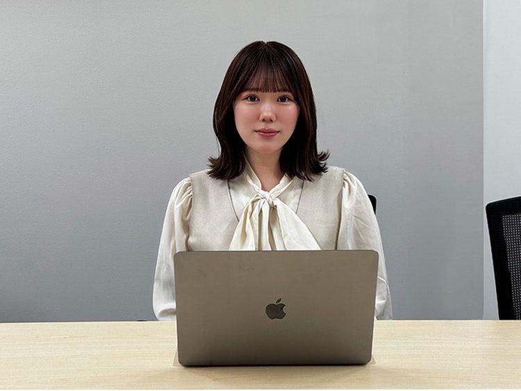 A person sitting at a desk with a computer Description automatically generated