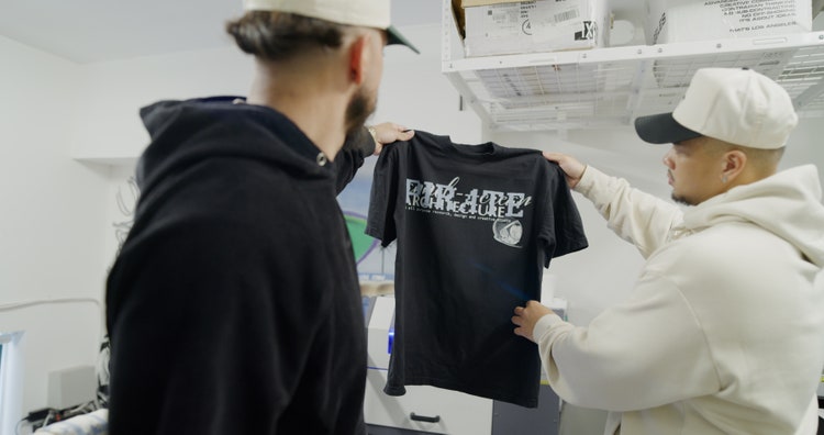 Image of Bryan Bonilla holding a tshirt.