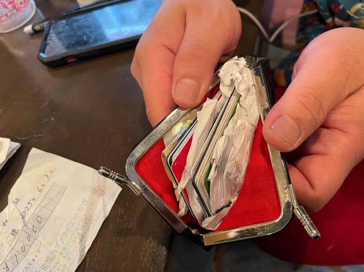 A person holding a wallet AI-generated content may be incorrect.