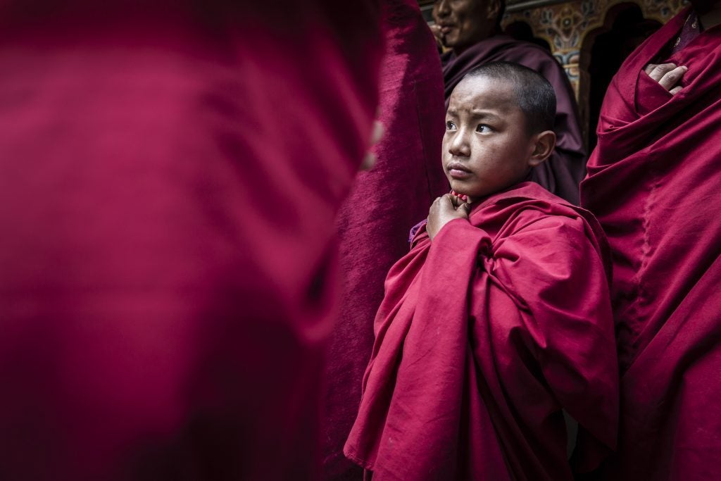 Novice-monk-in-courtyard-at-Paro-Dzong-during-festival-Paro-Bhutan-1024x683
